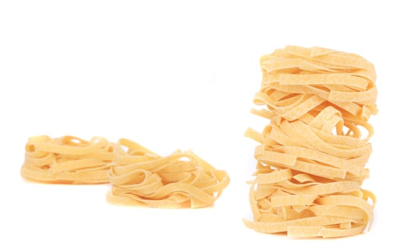 Italian pasta tagliatelle nest. Isolated on a white background.