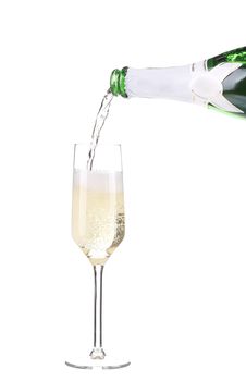 Champagne pouring in a glass. Isolated on a white background.