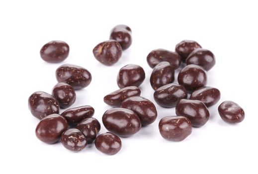 Dark brown dragee in chocolate covered. Isolated on a white background.