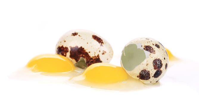 Raw and broken quail eggs. Isolated on a white background.