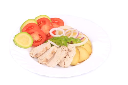 Sliced chicken fillet and vegetables. Isolated on a white background.