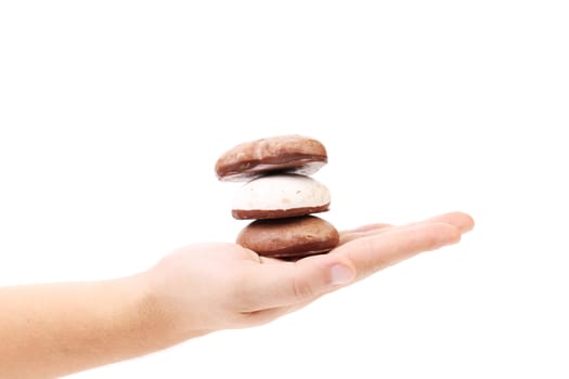 Hand holds heart shaped cookies. Isolated on a white background.