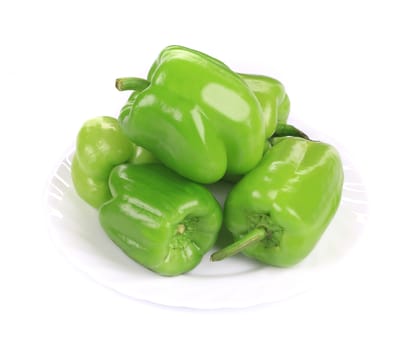Green peppers in the plate. Isolated on a white background.