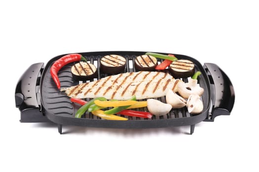 Grilled seabass with vegetables. Isolated on a white background.