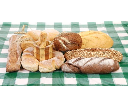 Fresh bread on tablecloth. Isolated on a white background.