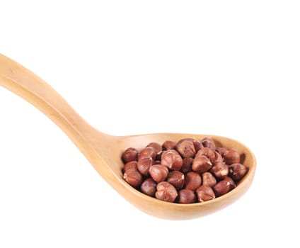 Spoon with hazelnuts. Isolated on a white background.