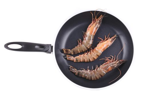 Raw tiger shrimp on frying pan. Isolated on a white background.