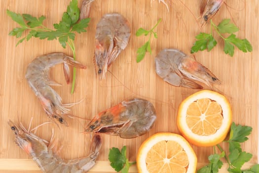Raw shrimps on cutting board.