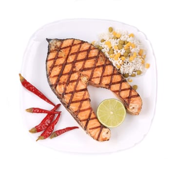Grilled salmon steak with rice and vegetables. Isolated on a white background.