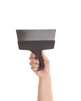 Hand holds metal spatula. Isolated on a white background.