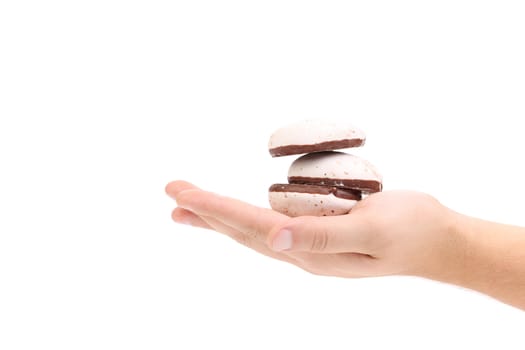 Hand holds heart-shaped biscuits. Isolated on a white background.