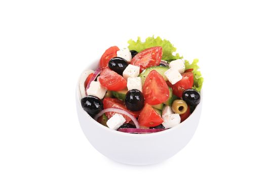 Greek salad in bowl. Isolated on a white background.