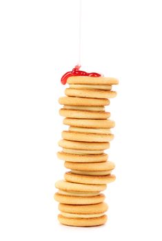 Stack of biscuits covered cherry jam. Isolated on a white background.