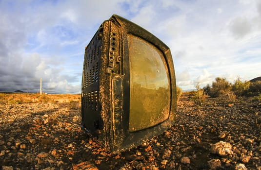 Abandoned Broken Television in the Desert on a Cloudy Day