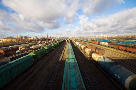 Freight train with color cargo containers passing railway station