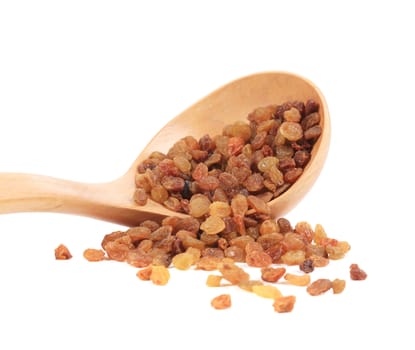 Wooden spoon with golden raisins. Isolated on a white background.