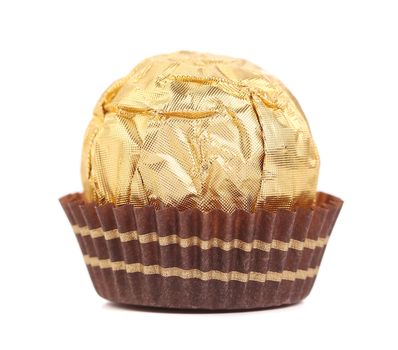 Sweet chocolate candy wrapped in golden foil. Isolated on a white background.