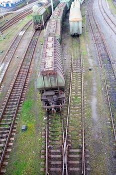 Freight train with color cargo containers passing railway station