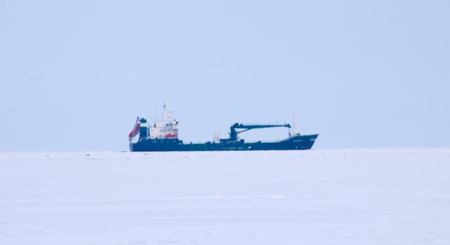cargo ship moves on a waterway in the winter