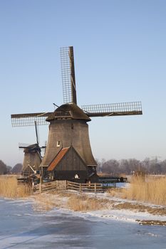 Two classic windmills in winter with blue sky