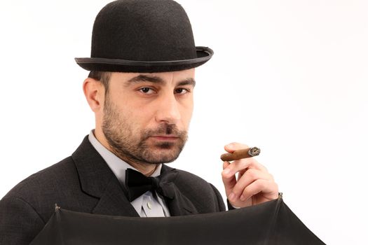man with bowler hat, cigar and  umbrella 
