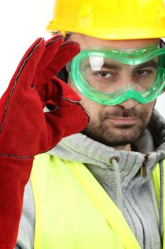 Worker with protective gear showing OK sign 