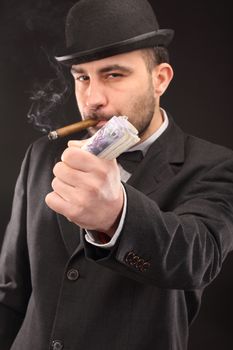 Portrait of man in suit with dollar bills 