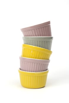 Stack of color ceramic bowls on white