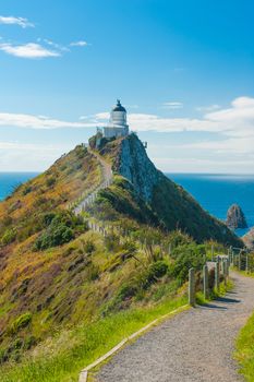 Lighthouse on Nugget Point. It is located in the Catlins area on the Southern Coast of New Zealand, Otago region. The Lighthouse is surrounded by small rock islands, nuggets