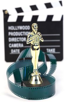fake Oscar award and movie clapper board , shallow dof