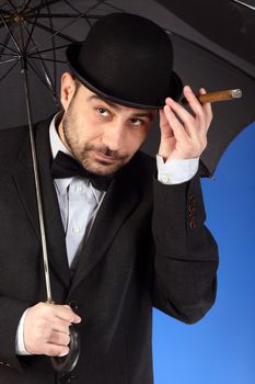 man with bowler hat, cigar and  umbrella 