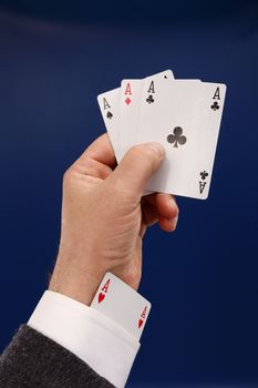 poker player cheating with four aces over blue