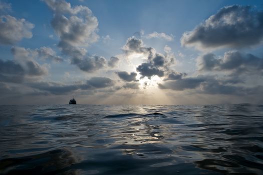 beautiful sunset with cloudy blue sky over the water of sea