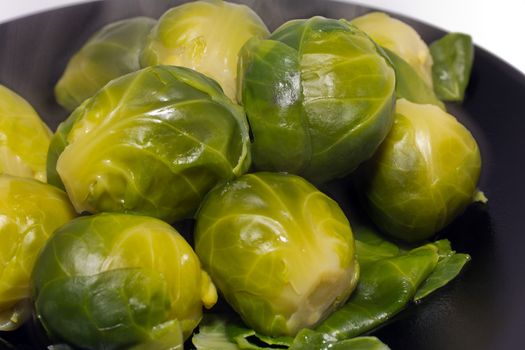 boiled brussel sprouts on the black plater