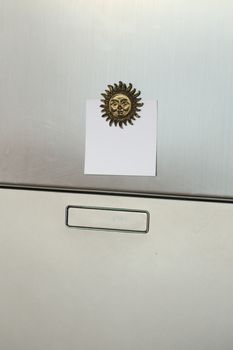 Blank paper on refrigerator door. 