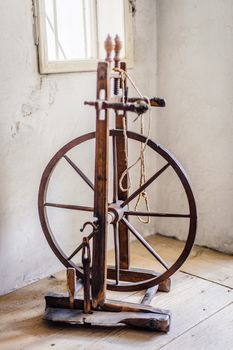 Old spinning wheel in a room of an austrian farm
