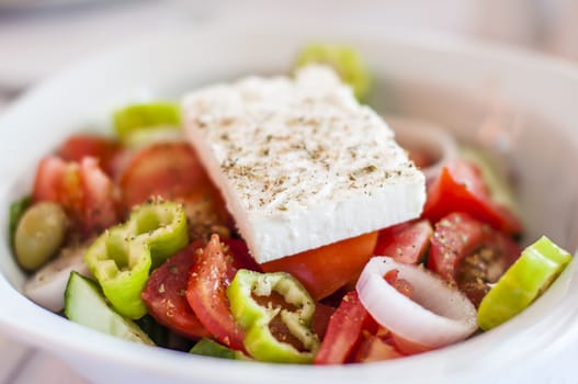 Authenic greek salad with feta, onion, tomato, olives and green peppers