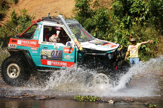 BAO LOC, VIETNAM- FEB 24: Racer at terrain racing car competition,motor cross stream that extreme off road with rock on water, competitor  adventure in championship spirit, Viet Nam, Feb 24, 2014