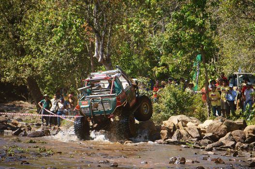 BAO LOC, VIETNAM- FEB 24: Racer at terrain racing car competition,motor cross stream that extreme off road with rock on water, competitor  adventure in championship spirit, Viet Nam, Feb 24, 2014