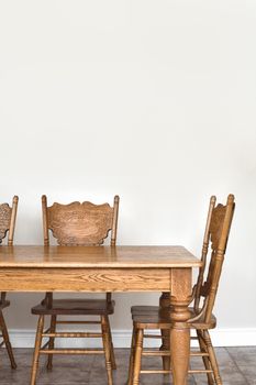 Wooden Dining room table and chair details and blank wall for your text, image or logo.