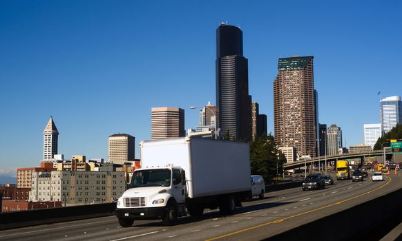 Vehicles travel down Interstate 5 infron of Seattle Downtown