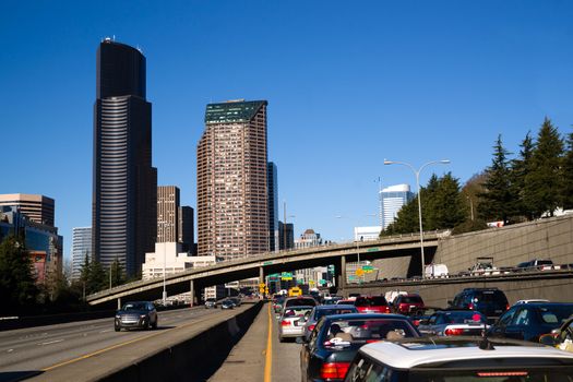 Vehicles travel down Interstate 5 infron of Seattle Downtown