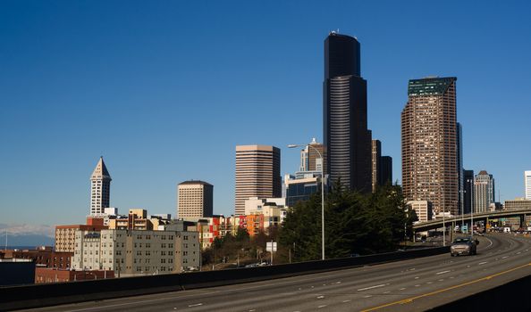 Vehicles travel down Interstate 5 infron of Seattle Downtown