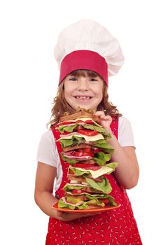 happy little girl cook hold dish with tall sandwich 