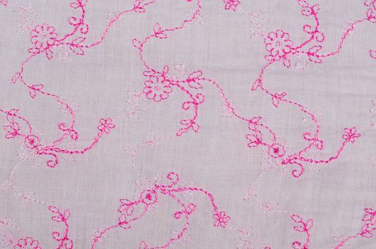 Pink  embroidery craft on a light cotton fabric