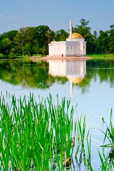 structure with a golden roof near the lake in the park