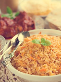 Indian cuisine biryani rice and chicken curry with retro effect.