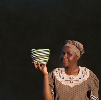 Traditional South African Zulu woman basket sales woman on blackboard background