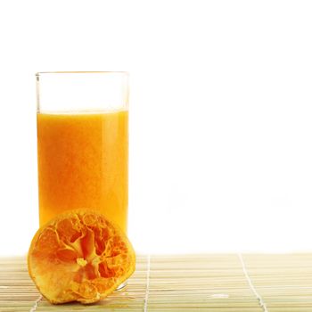 Fresh Orange juice in a glass on bamboo