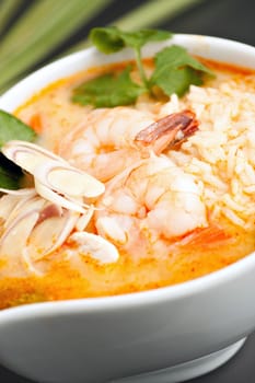 Thai shrimp soup bowl with nice garnish. Shallow depth of field.